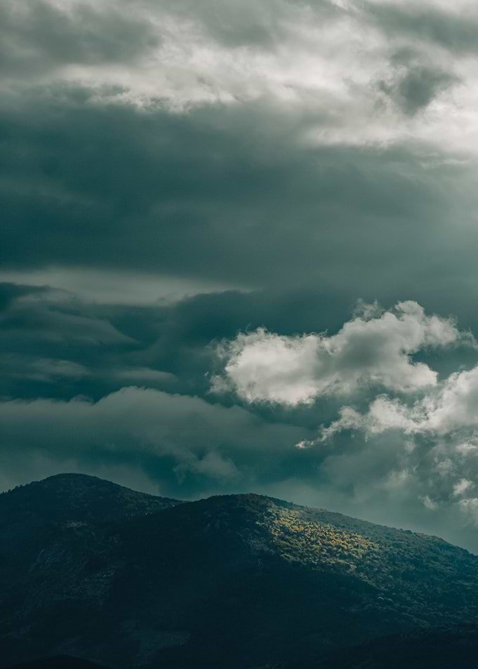Dramatic Mountain Landscape Under Stormy Clouds