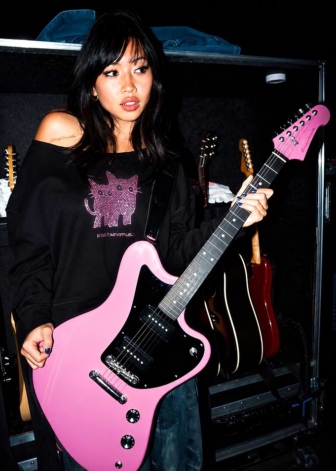 Beabadoobee Holding Pink Electric Guitar