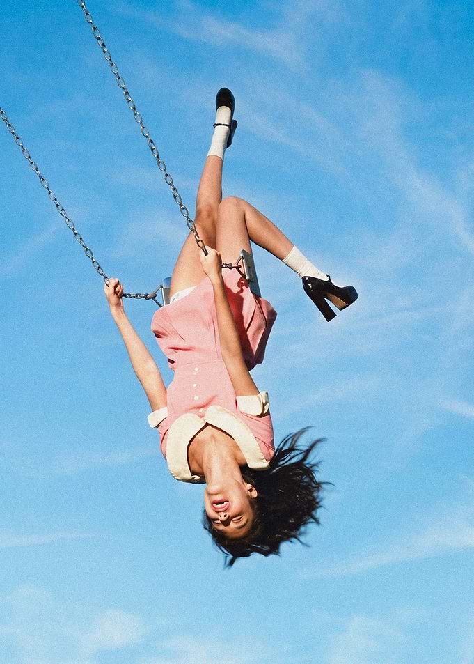 Woman Hanging Upside Down on Swing