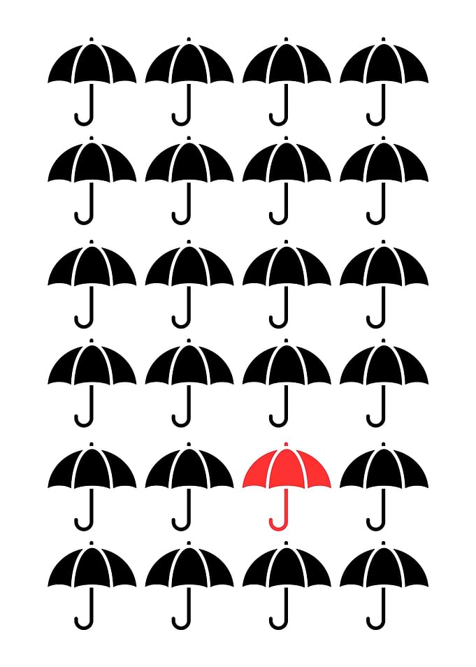 Minimalist Red Umbrella Among Black Umbrellas