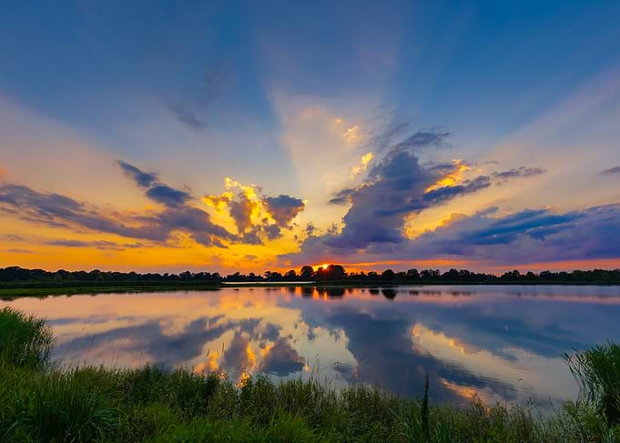 Vibrant Sunset Over Calm Lake