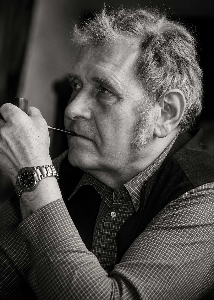 Thoughtful Older Man Smoking Pipe