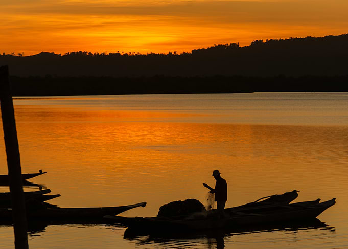 Fisherman at Sunset on Calm Water