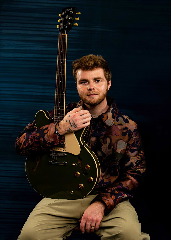 Musician posing with Gibson guitar