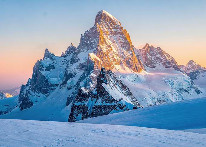 Golden Sunrise Over Snowy Mountain Peaks