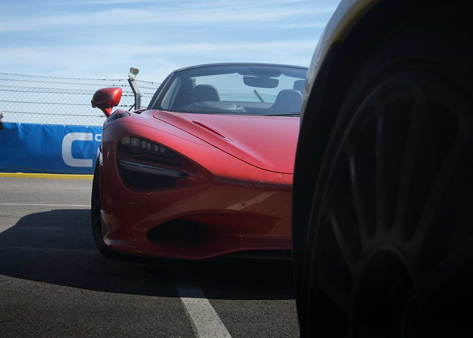 Red McLaren Supercar at Racetrack