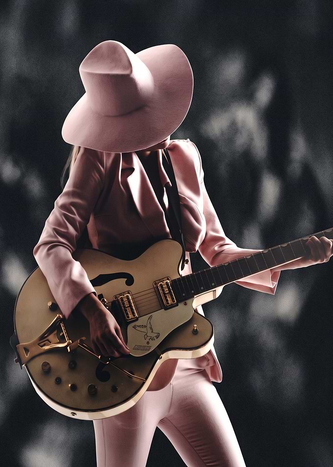 Musician in Pink Suit Playing Guitar