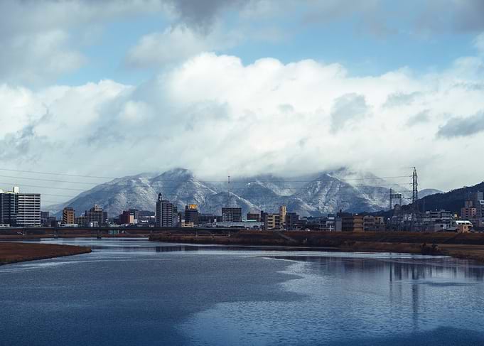 Snow-capped mountains over Japanese city