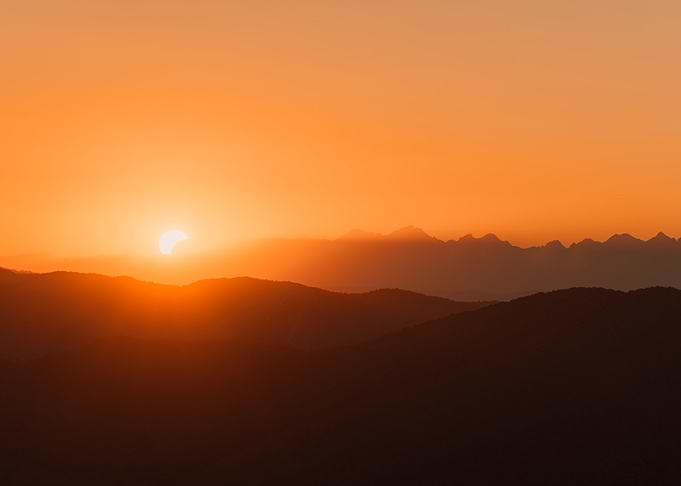 Golden Sunset Eclipse Over Mountain range
