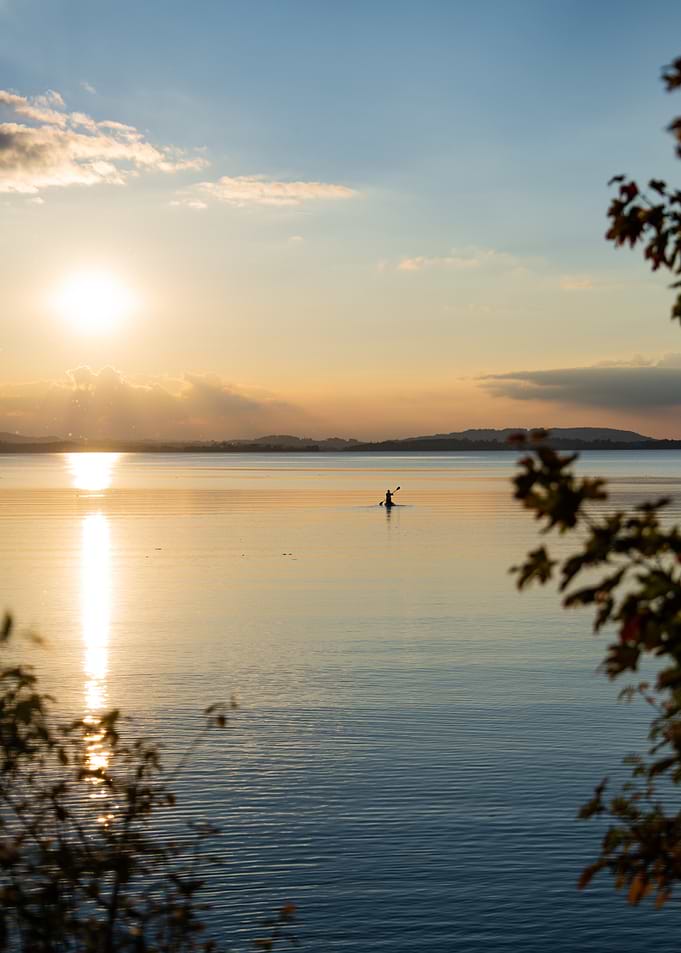 Lone Paddleboarder at Sunset