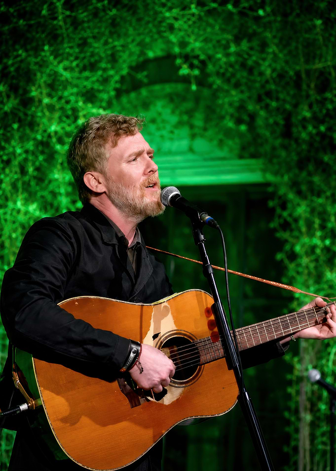 Glen Hansard performing with acoustic guitar