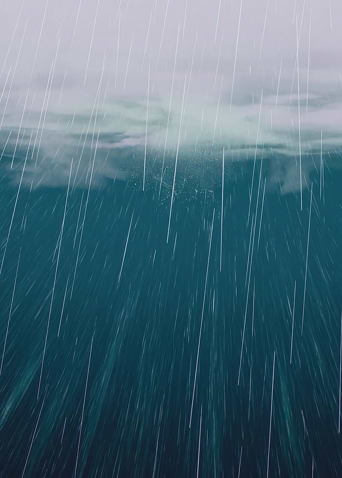 Vertical Rain Over a Teal Sea