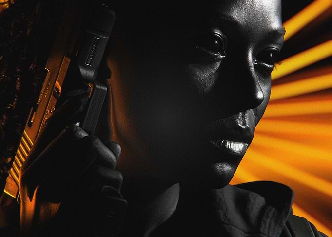 Woman Holding Handgun in Dramatic Lighting