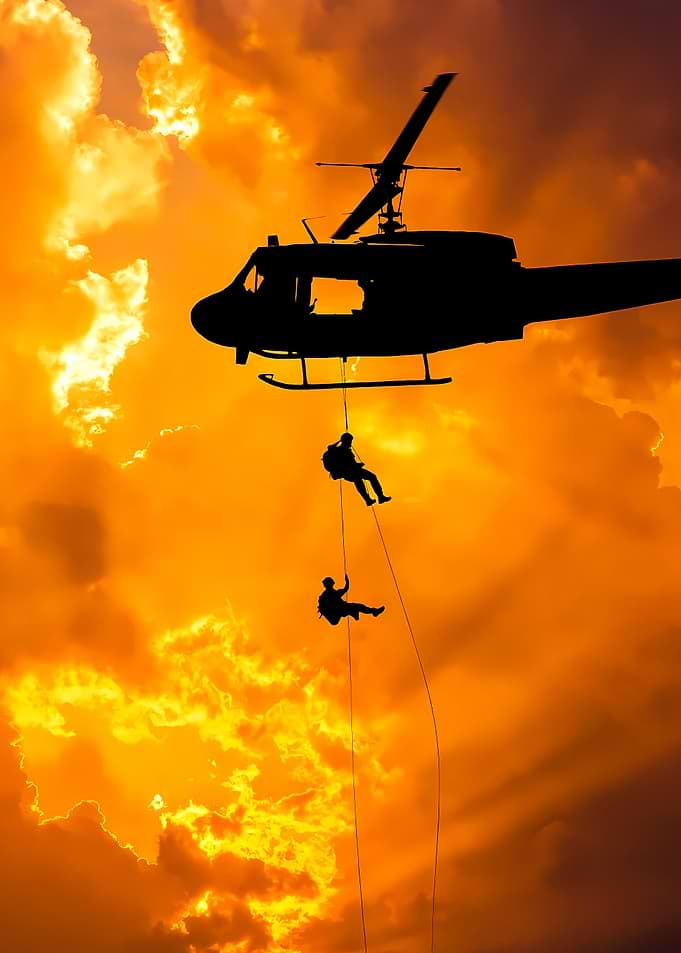 Military Helicopter Rappelling at Sunset