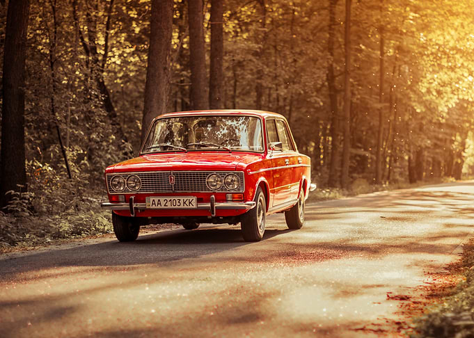 Vintage Red Lada on Forest Road