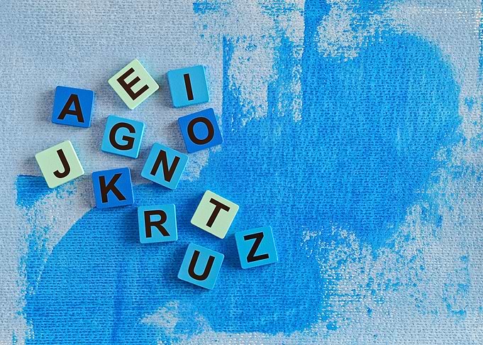 Scrabble Tiles on Blue Painted Background