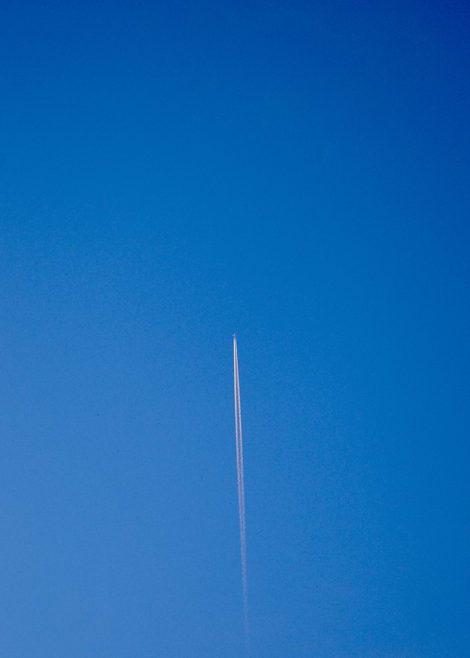 Airplane leaving a contrail in sky