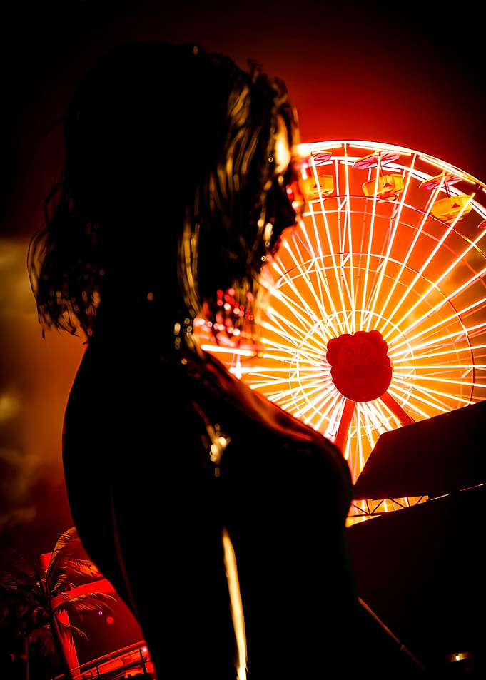 Silhouette Woman Before Glowing Ferris Wheel