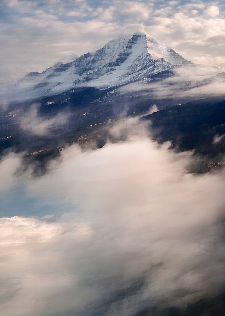 Snow-Capped Mountain Peak Above Clouds
