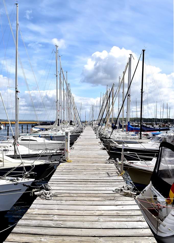 Wooden Pier with Sailboats at Marina