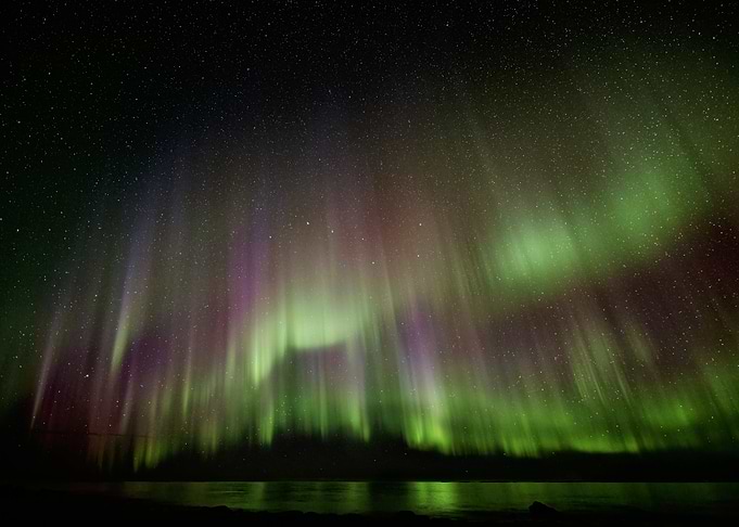 Vibrant Aurora Borealis Over Water