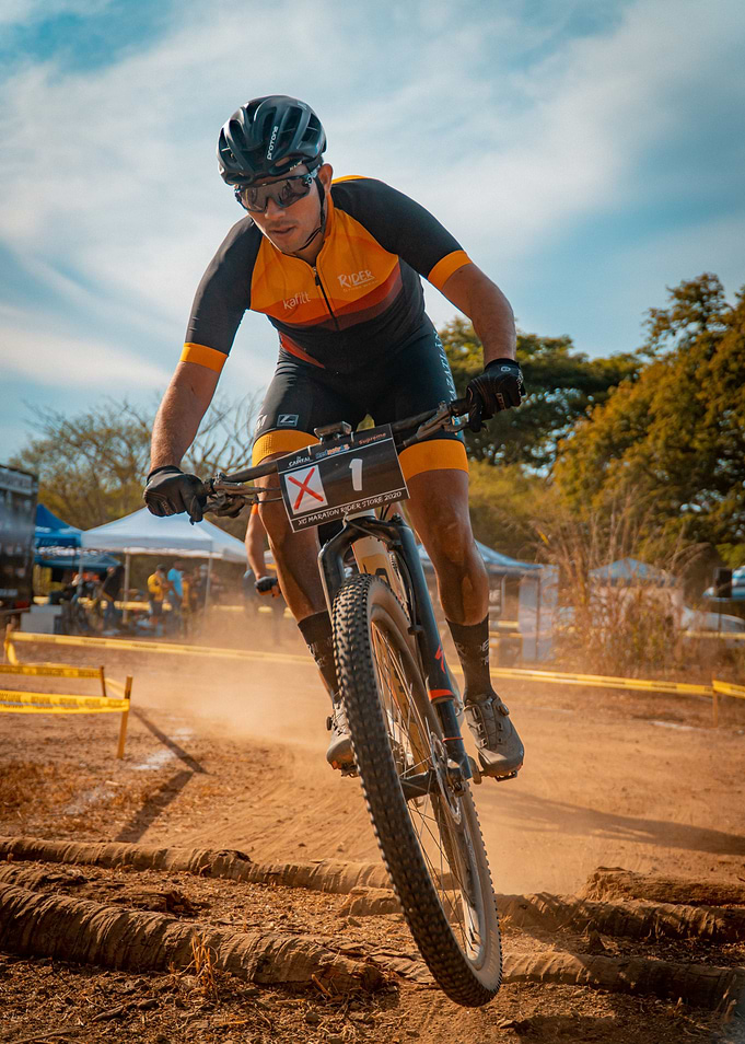 Mountain Biker Racing on Dirt Track
