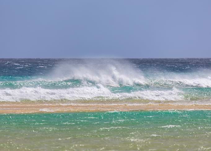 Crashing Ocean Waves on Sandy Shore