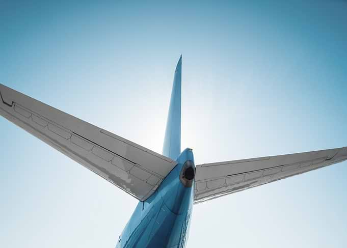 Airplane Tail Against Bright Sky