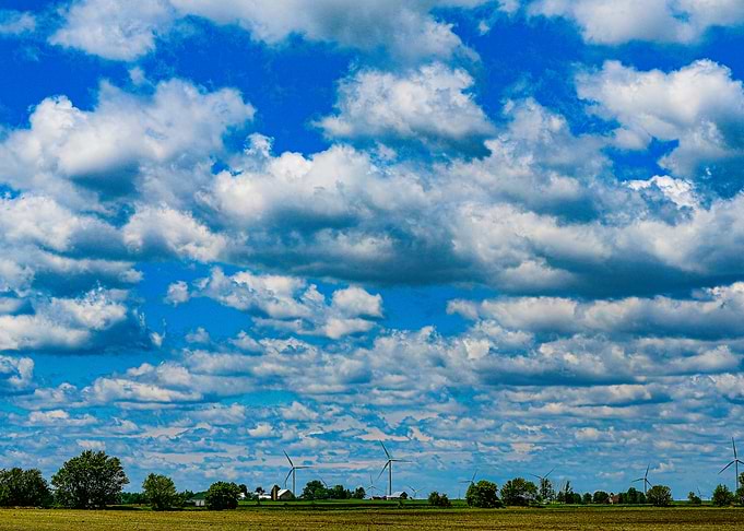 Wind Turbines Under Dramatic Cloudy Sky