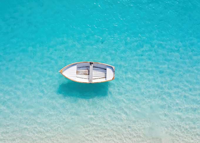 Small wooden boat in turquoise water