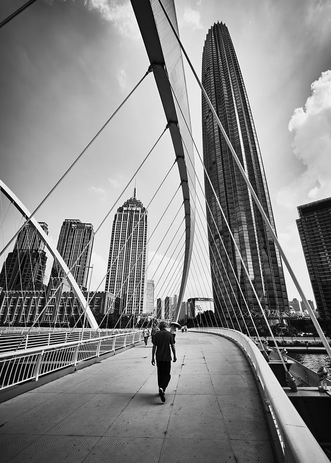 Person walking on modern city bridge