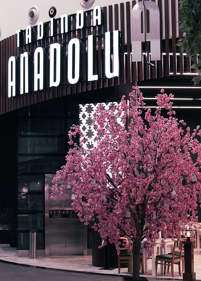 Tadinda Anadolu Restaurant behind Faux Cherry Blossom Tree inside of Istanbul Airport