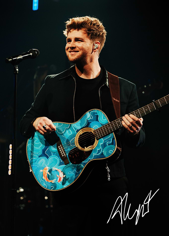 Singer performing with custom koi guitar