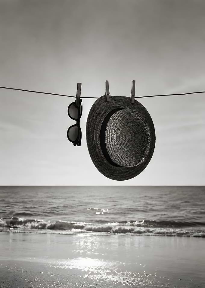 Retro Sunglasses & Straw Hat on Clothesline