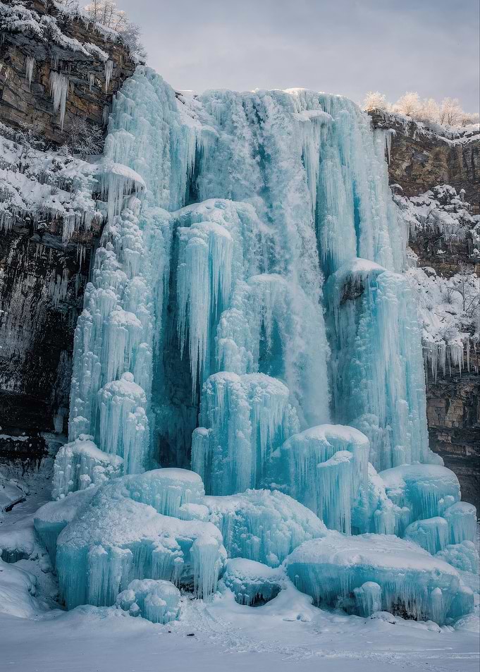 Frozen Waterfall in Winter Landscape