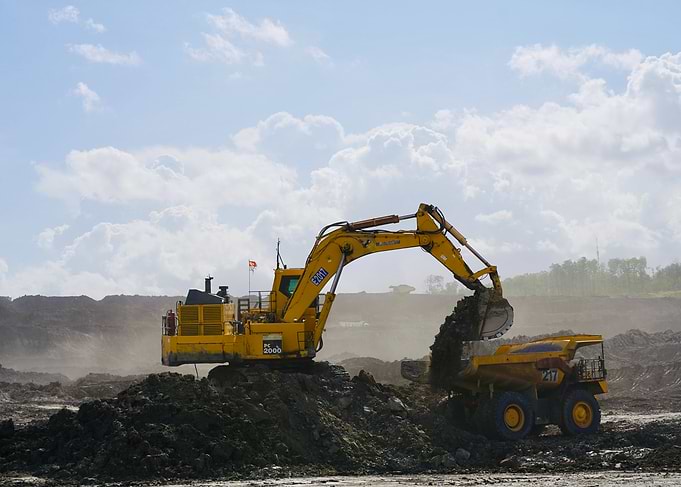 Yellow Excavator Loading Mining Truck