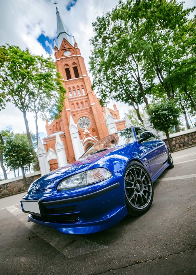 Blue Honda Civic by Historic Church