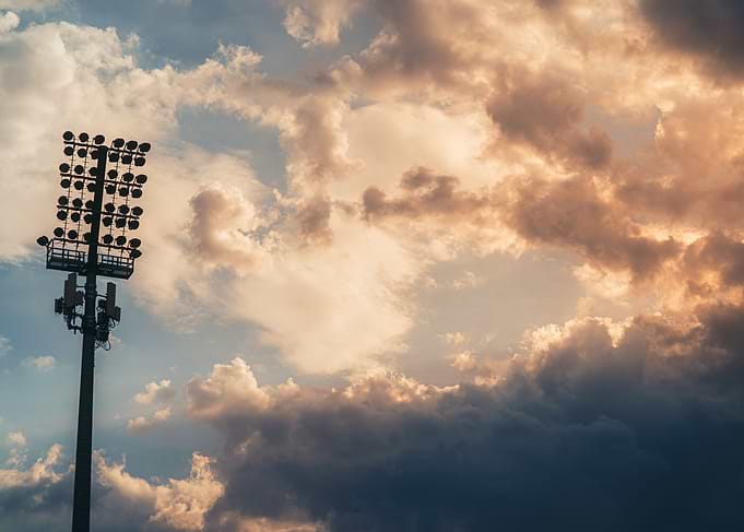 Stadium Floodlight Against Dramatic Sunset Sky