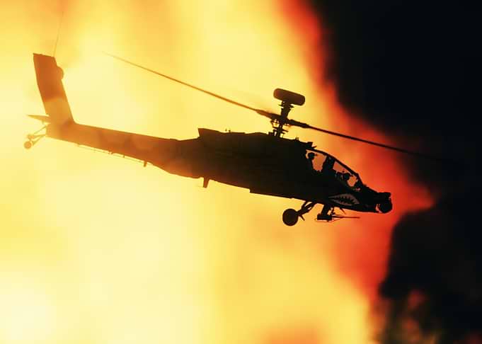 Apache Helicopter Silhouette Against Fire