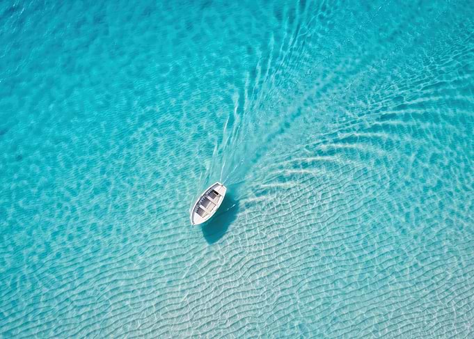 Aerial view of boat in turquoise water