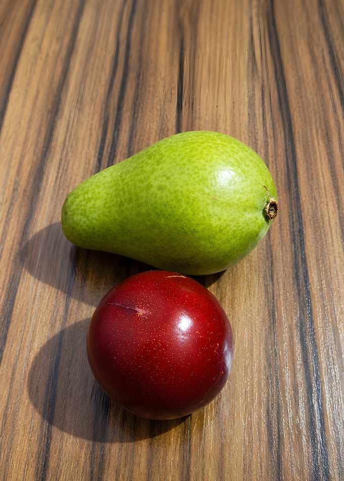 Fresh Pear and Plum on Wood