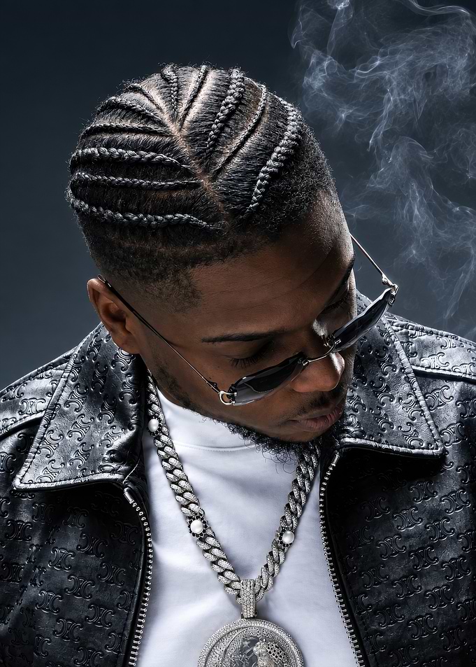 Stylish Man with Braids and Jewelry