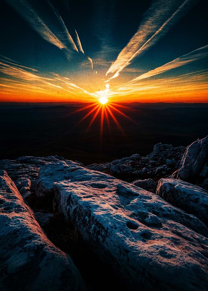 Dramatic Mountain Sunset with Contrails