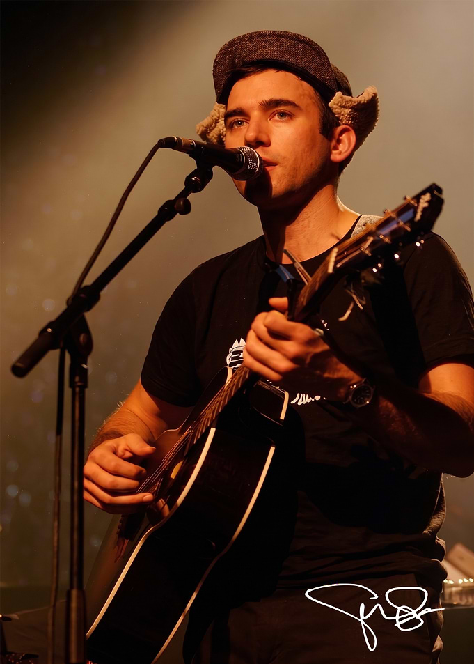 Singer performing with acoustic guitar