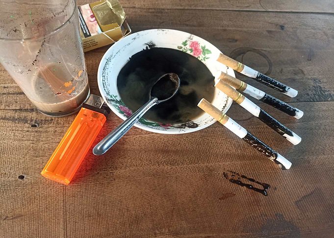 Coffee and Cigarettes on Wooden Table
