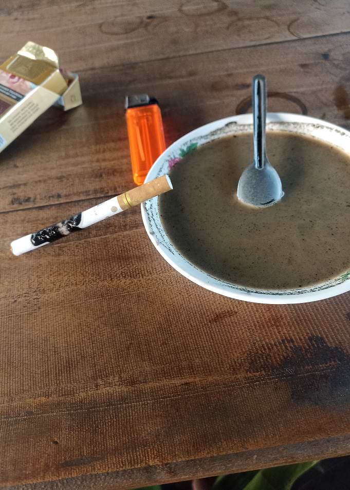 Coffee and Cigarette on Wooden Table