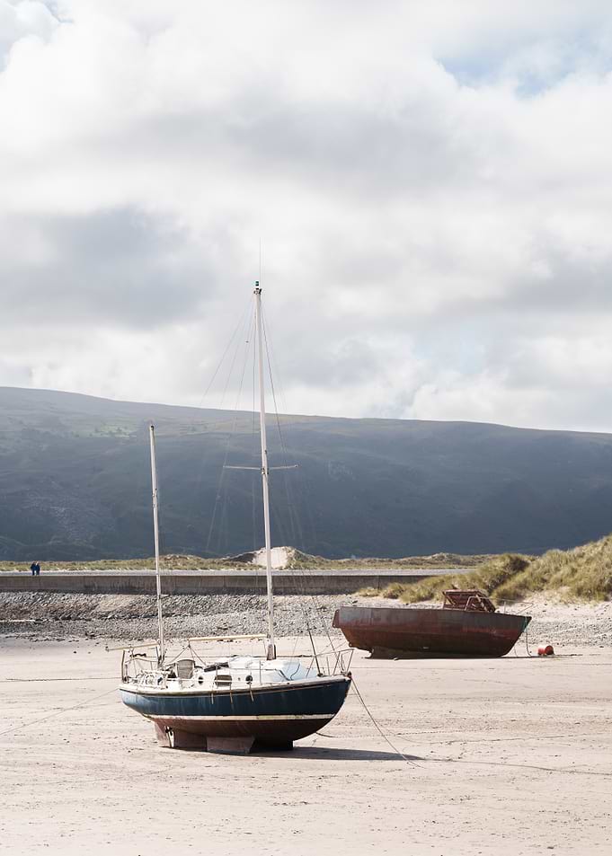Abandoned boats on a sandy beach