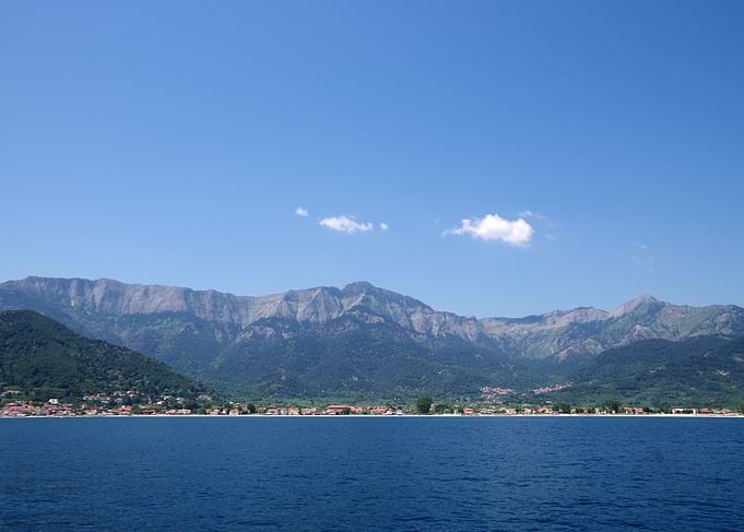 Coastal Village Beneath Mountain Range