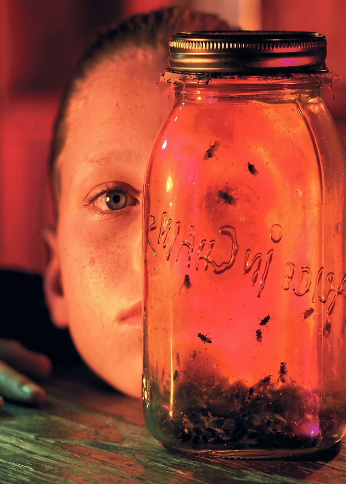 Child Observing Flies in Mason Jar