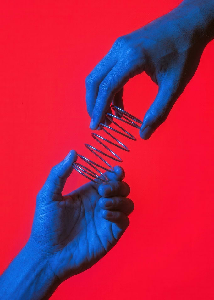Blue Hands Holding Metal Spring